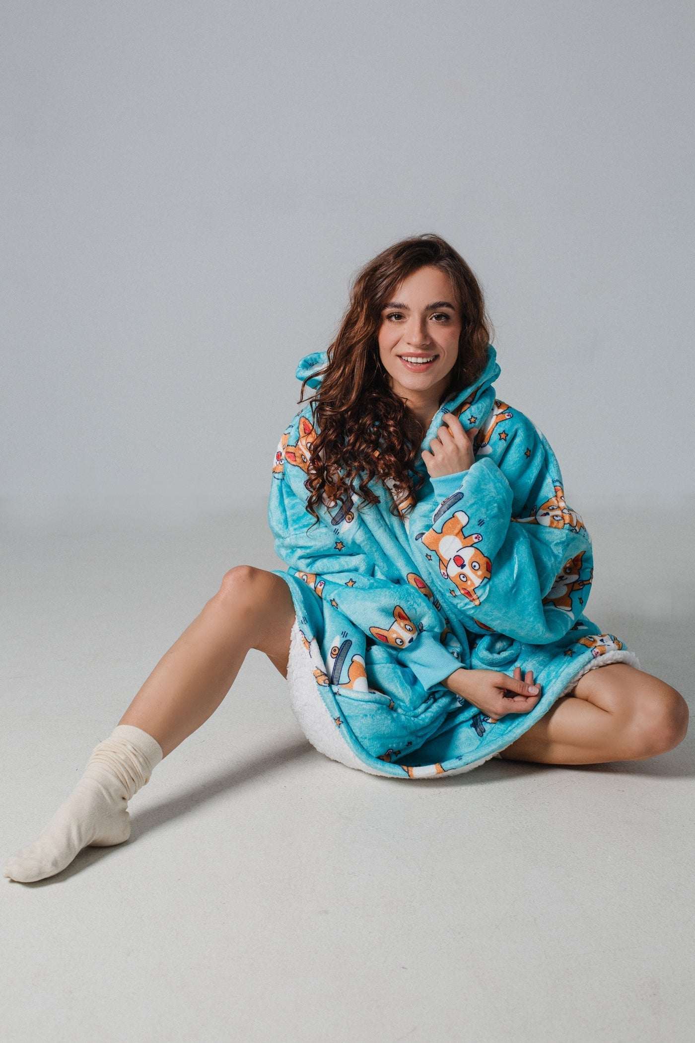 Cozy SNUGLFIT™ Hoodie Blanket in Sporty Corgi print, perfect for warmth and comfort indoors or outdoors.