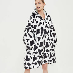 SNUGLFIT™ Hoodie Blanket Cow print, oversized wearable blanket for comfort and warmth.