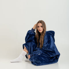 Navy blue SnuglFit™ hoodie blanket providing warmth and comfort.