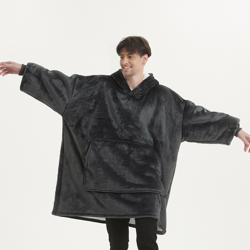 Smokey grey SnuglFit™ hoodie blanket worn by a person, showcasing its oversized and cozy Sherpa fleece design.